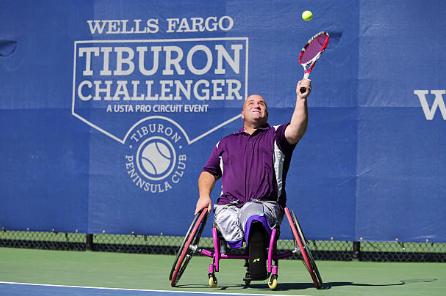 david sitting in tennis wheelchair talking at camera