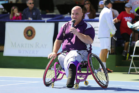 david on tennis court talking into microphone